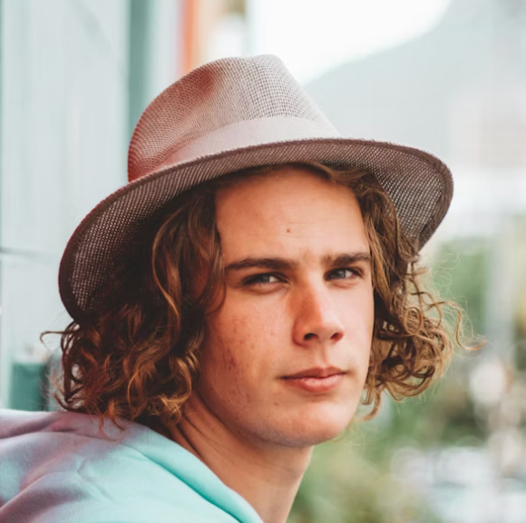 Person in hat looking away