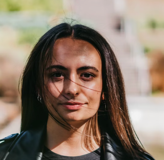 Woman smiling at camera outdoors